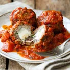 Italian Meatballs Stuffed with Fresh Mozzarella & Ricotta Cheeses Served in Tomato Basil Sauce 